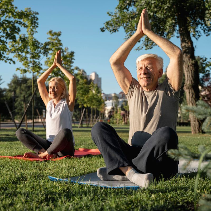 older-couple-practicing-yoga-outdoors.jpg